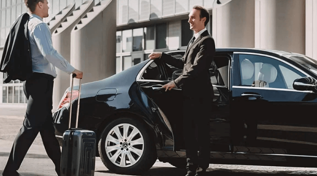 Two men in business suits entering a black car, ready for a meeting or event.
