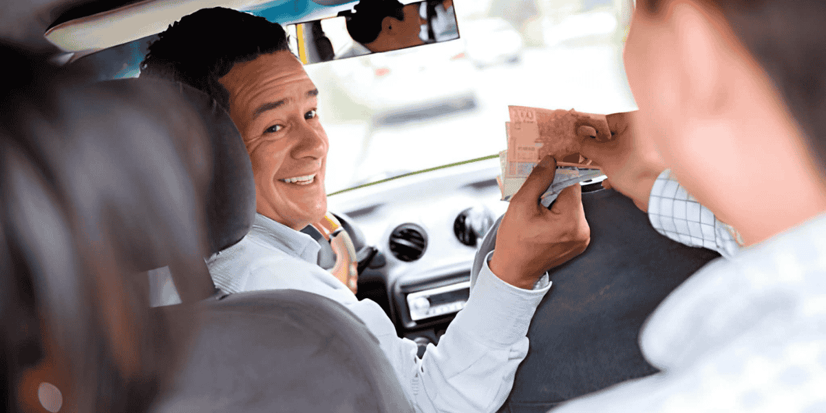 A man in the back seat of a car, casually resting with a focused look as he observes the surroundings.