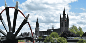 A large wheel characterized by a black surface and vibrant red details, emphasizing its bold design.